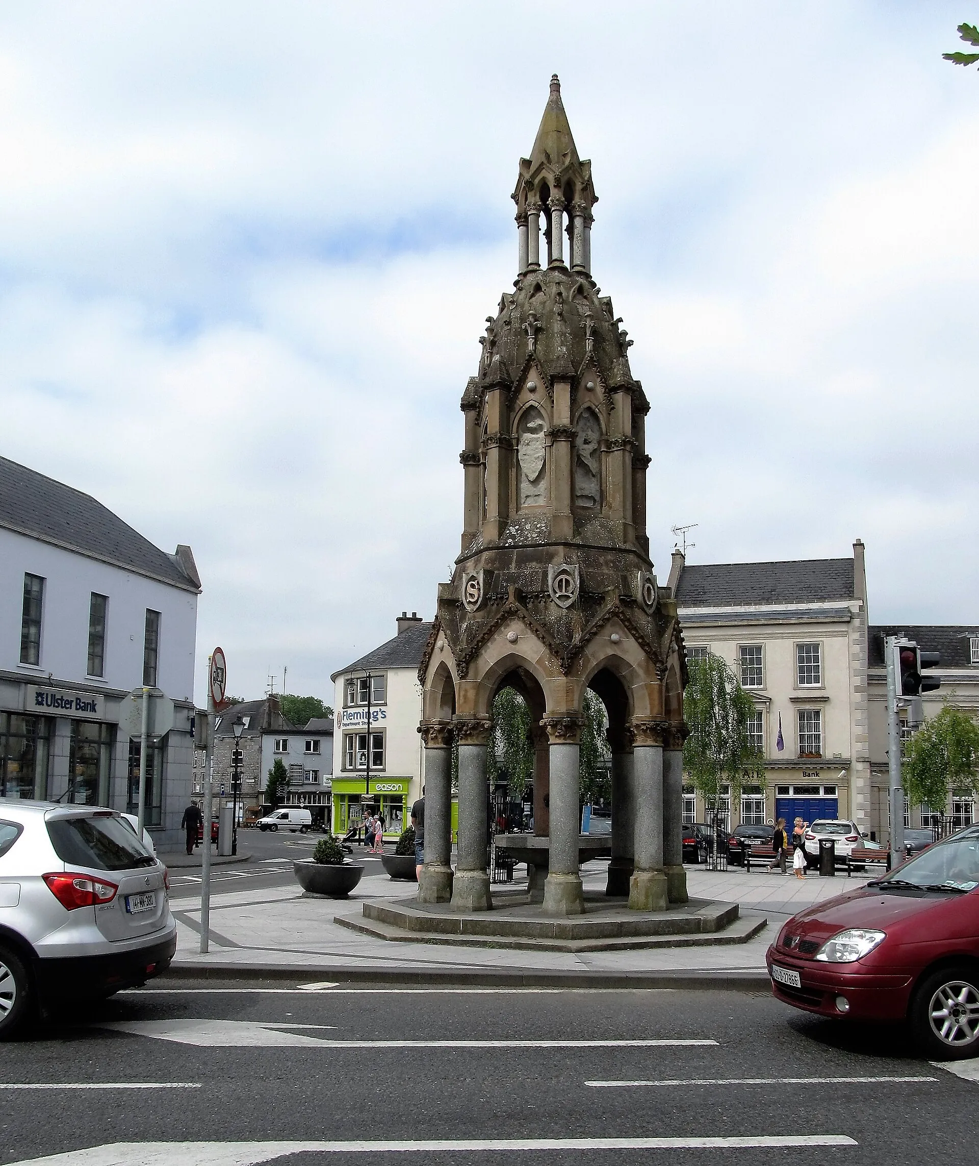 The Rossmore Memorial in the Diamond, an ornate drinking fountain of grey marble columns under a stone spire.